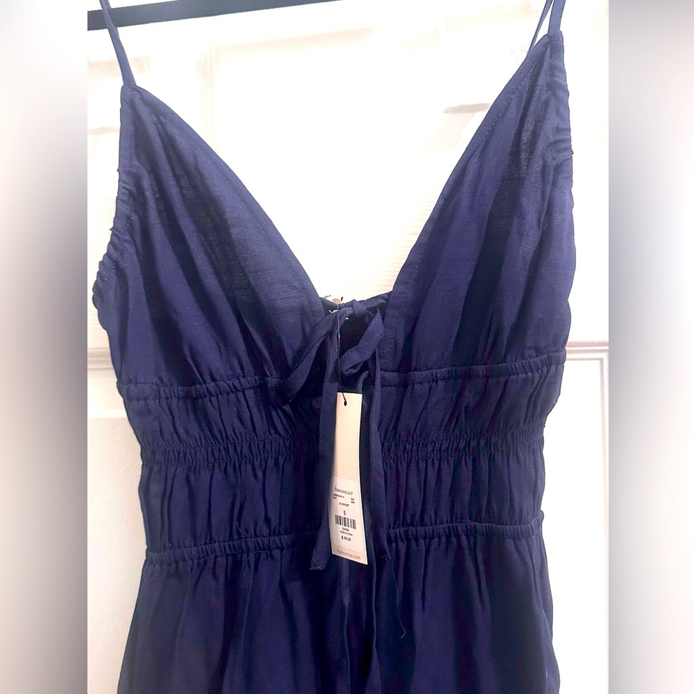 Brand new (size small) spaghetti strap flowy navy blue pants romper. Never worn.